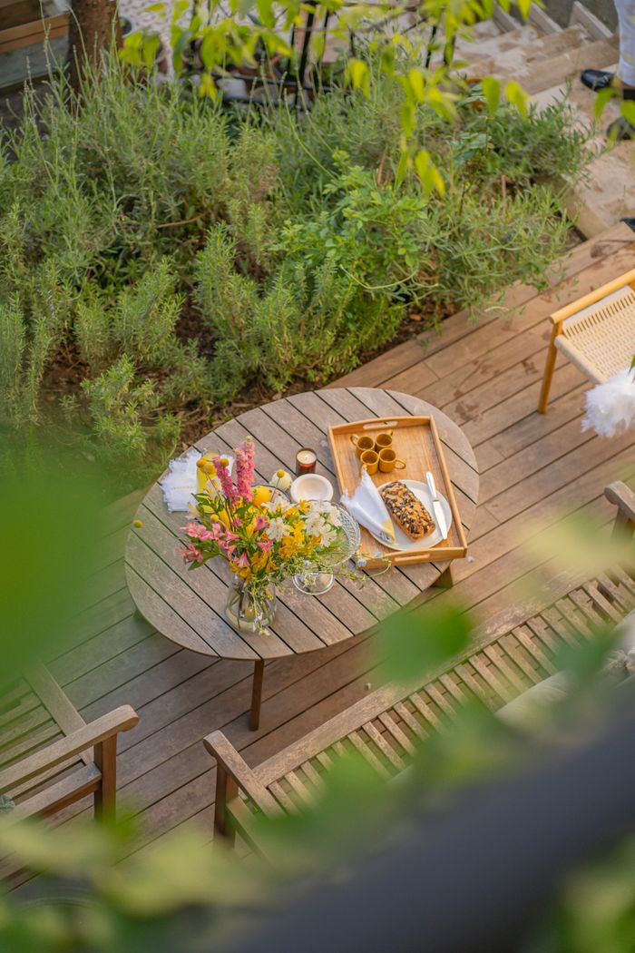A charming outdoor table arrangement with flowers and snacks. Perfect for leisure and relaxation.